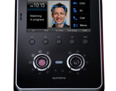 High-tech facial recognition device with display screen showing a smiling man.